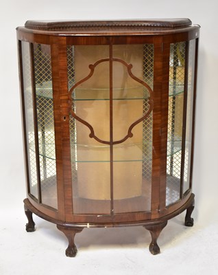 Lot 47 - A 1940s walnut bow-fronted display cabinet...