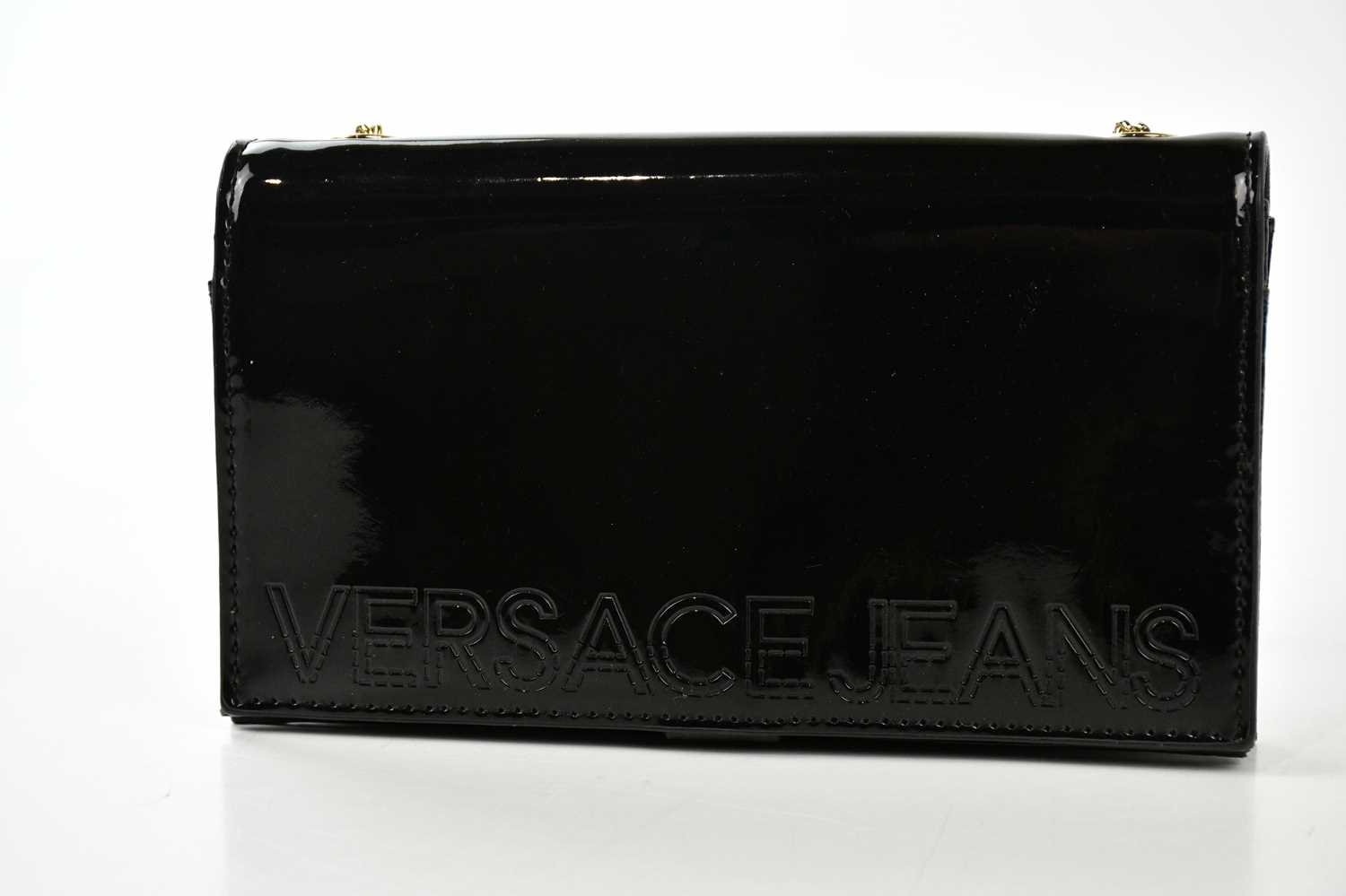 Lot 783 - VERSACE JEANS; a black patent leather clutch...
