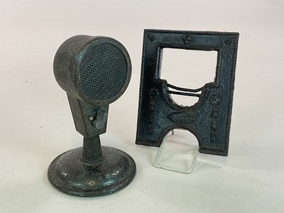 Lot 135 - An iron tabletop microphone with bakelite...