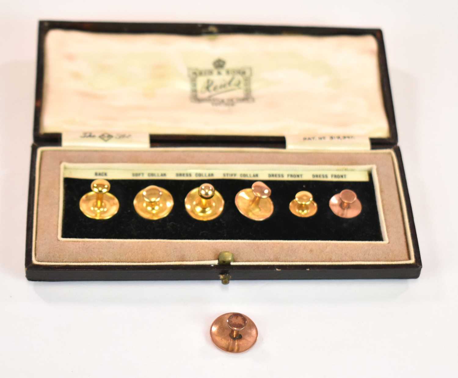 Lot 1166 - A cased set of 9ct gold shirt studs, the