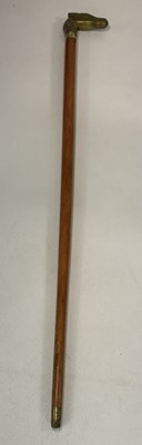 Lot 188 - A walking stick with a brass handle modelled...