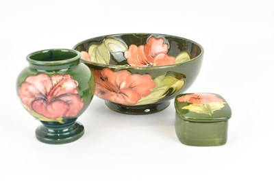 Lot 304 - WALTER MOORCROFT; three pieces of 'Hibiscus'...