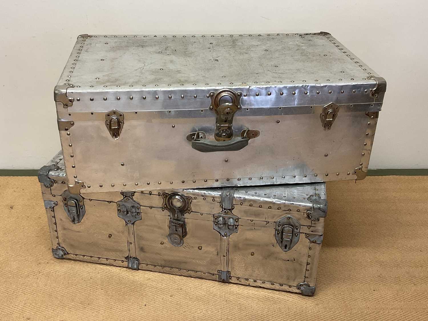 Lot 624 - Two aluminium travelling trunks with rivet...