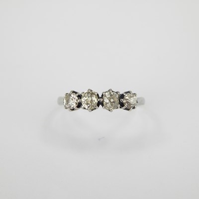 Lot 696 - An 18ct white gold four-stone diamond ring,...