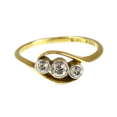 Lot 693 - An 18ct gold three-stone diamond ring, the...