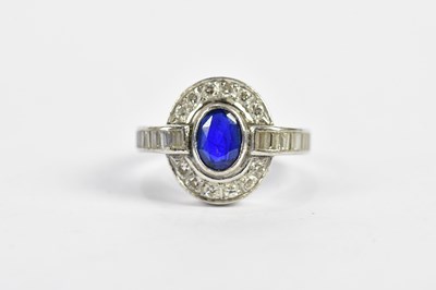 Lot 100 - A white metal sapphire and diamond ring with...