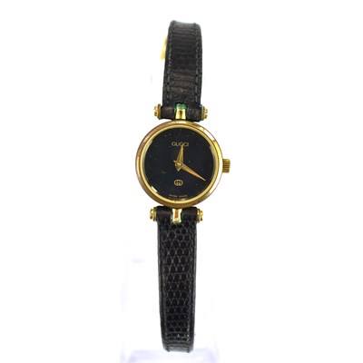 Lot 874 - GUCCI; a ladies' dress watch, the black dial...