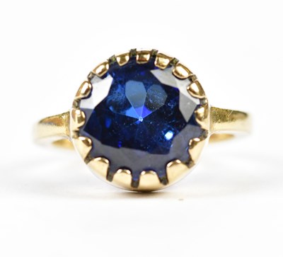 Lot 234 - A synthetic blue stone dress ring.