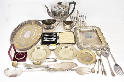 Lot 595 - A three-piece silver plated tea set, a toast...