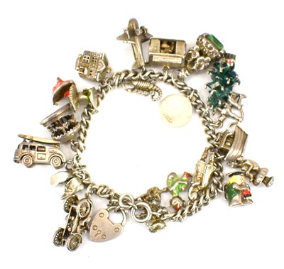 Lot 756 - A silver charm bracelet with seventeen charms...