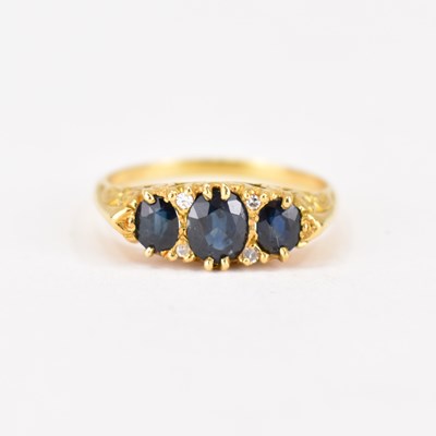 Lot 707 - An 18ct gold sapphire and diamond ring in a...