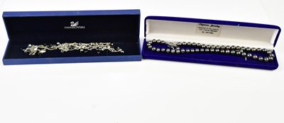 Lot 2535 - A black pearl necklace and matching ear studs,...