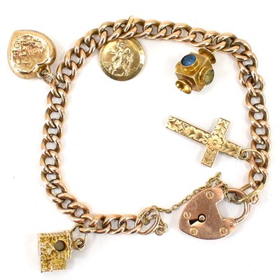 Lot 752 - A 9ct rose gold charm bracelet with five gold...