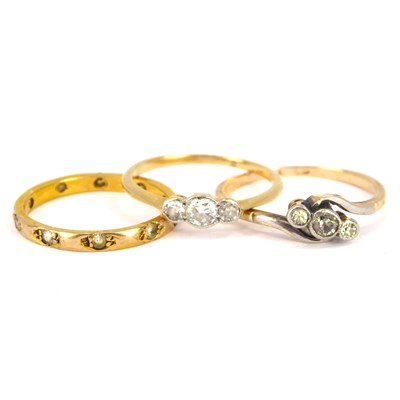 Lot 740 - Three 9ct gold rings comprising a crossover...