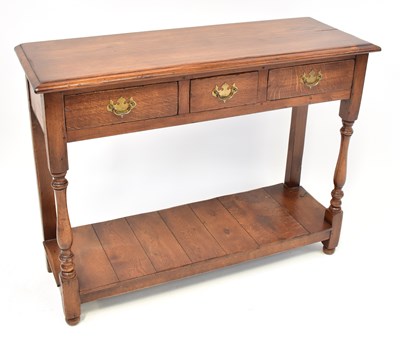 Lot 24 - A reproduction oak side table with three...