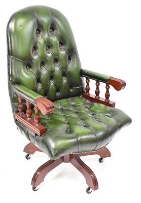 Lot 27 - A modern reproduction swivel office chair with...
