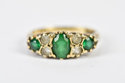 Lot 146 - A 9ct yellow gold emerald and diamond ring in...