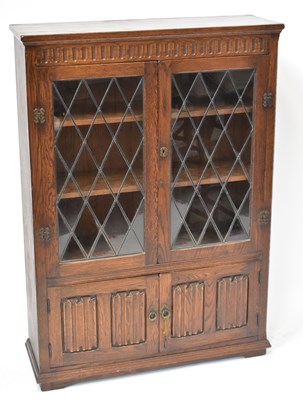 Lot 35 - A mid-20th century oak cabinet with leaded...