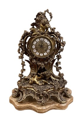 Lot 108 - A modern ornate brass mantel clock decorated...