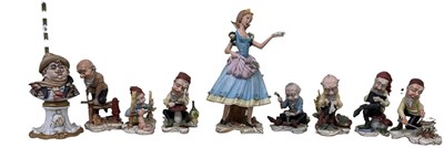 Lot 623 - CAPODIMONTE; a set of eight porcelain figures '...