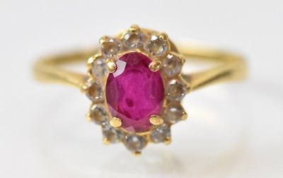 Lot 1254 - An 18ct yellow gold ruby and diamond set...