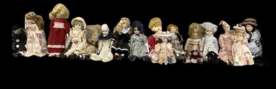 Lot 506 - A group of eighteen porcelain headed dolls,...