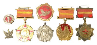 Lot 373 - A group of five Korean and Chinese medals...