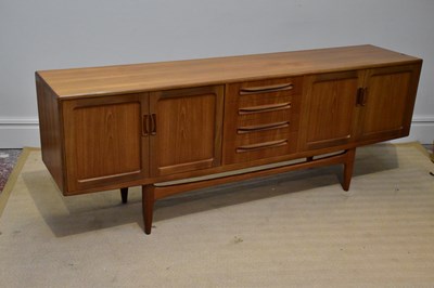 Lot 217 - G-PLAN; a teak sideboard with four central...