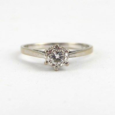 Lot 689 - An 18ct white gold solitaire ring claw set...