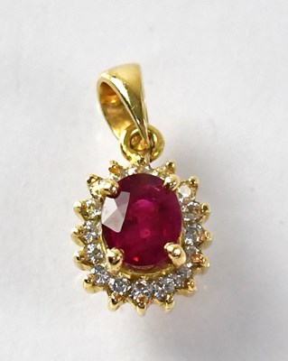 Lot 767 - An 18ct gold ruby and diamond cluster pendant,...