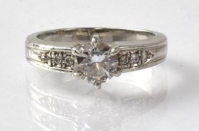 Lot 677 - A platinum ring with claw set diamond, approx....