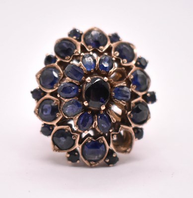 Lot 399 - A large yellow metal and sapphire floral...