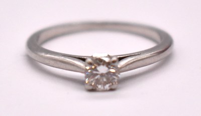 Lot 383 - CARTIER; a platinum and diamond solitaire ring,...