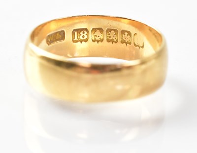 Lot 713 - An 18ct gold wedding band, stamped '18', size...