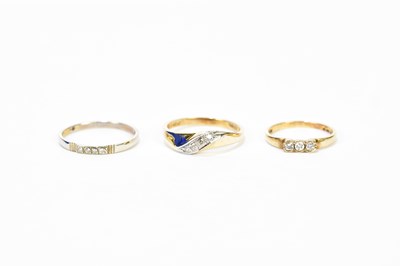 Lot 173 - A 9ct yellow gold three stone diamond ring and...