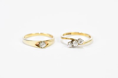 Lot 180 - A 9ct yellow gold three stone diamond ring,...