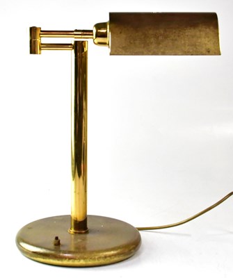 Lot 125 - A brass reading lamp with adjustable brass...