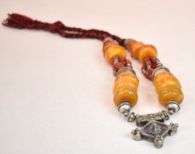 Lot 422 - A Sudanese amber white metal and cloth...