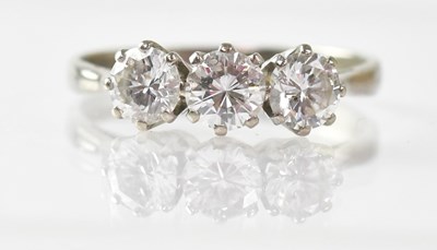 Lot 694 - An 18ct white gold three-diamond ring, the...