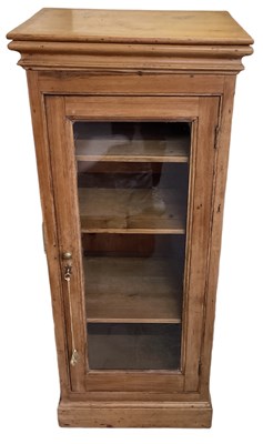 Lot 61 - A pine single door display cabinet with glazed...