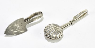 Lot 2522 - Two hallmarked silver napkin clips, the shield...