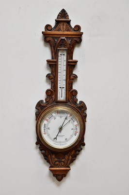 Lot 421 - A late Victorian carved oak aneroid barometer,...