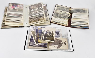 Lot 2643 - Three albums containing postcards, including...