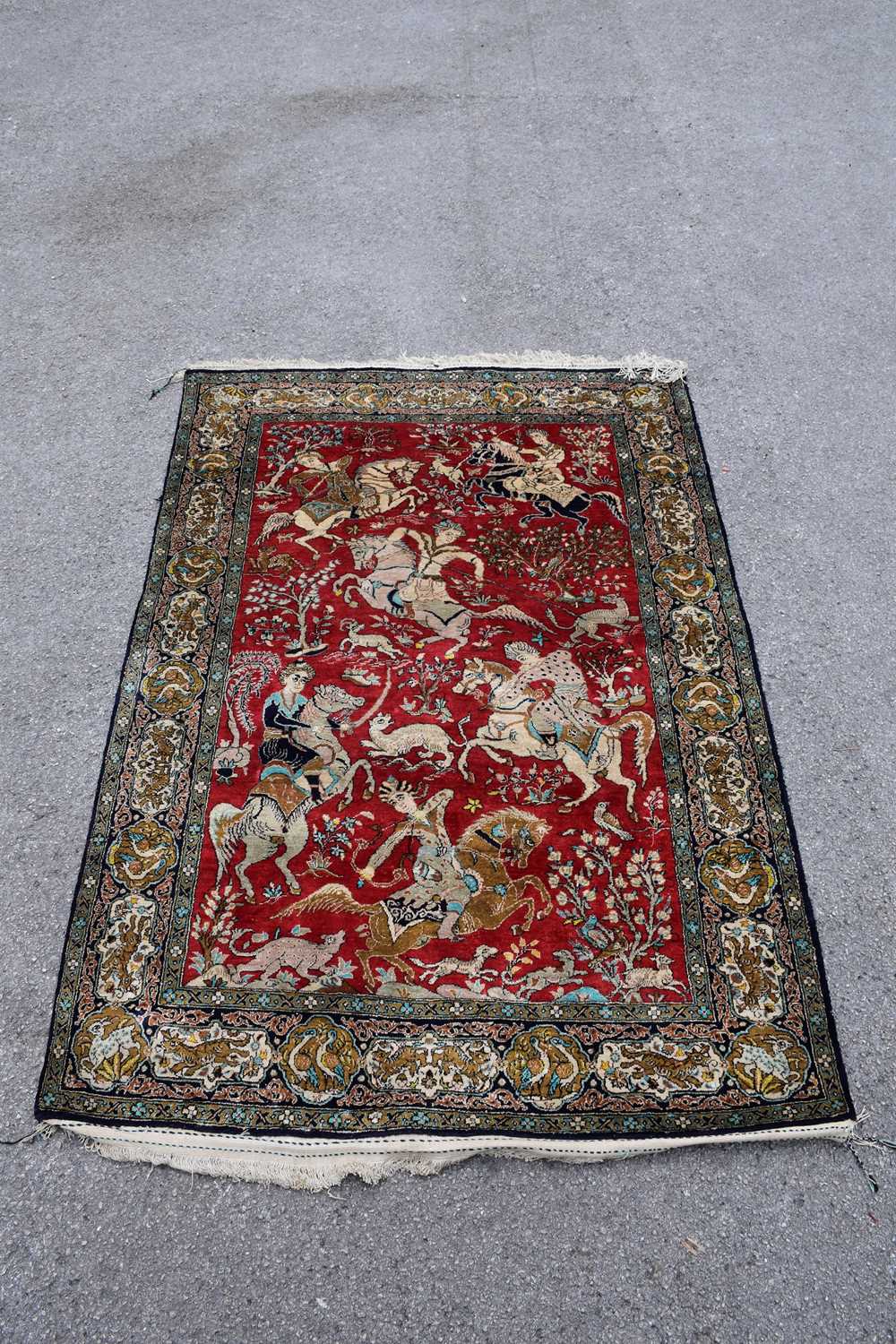 Lot 444 - An Eastern style part silk rug, decorated with...