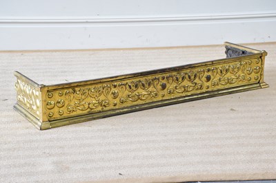 Lot 791 - An Art Nouveau brass fender with embossed...