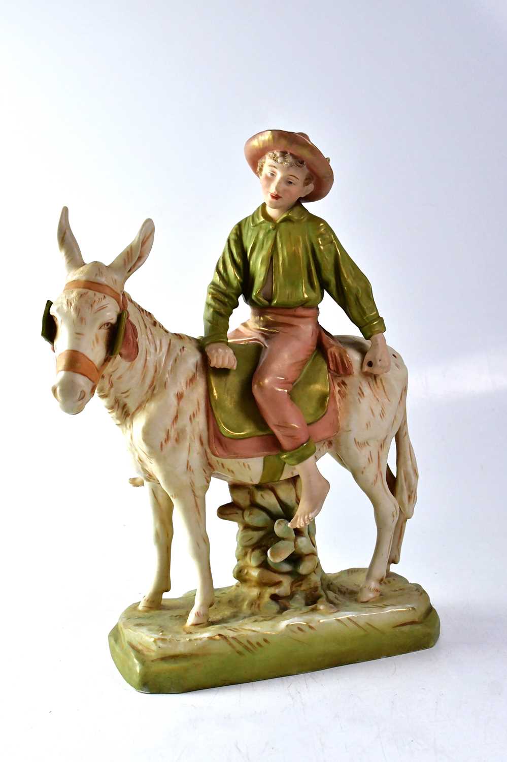 Lot 266 - ROYAL DUX; a figure of a boy riding a donkey,...