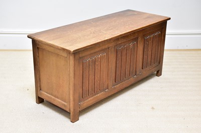 Lot 52 - A 1950s oak blanket chest with linen fold...