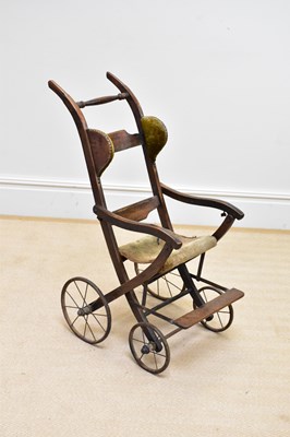 Lot 111 - A late Victorian stained beech push chair.