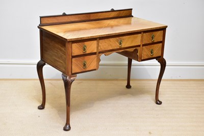 Lot 157 - A 1950s walnut kneehole dressing table with an...