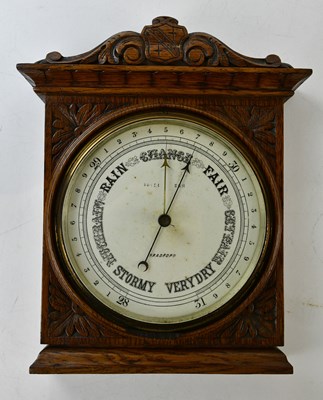 Lot 422 - An early 20th century carved oak aneroid...